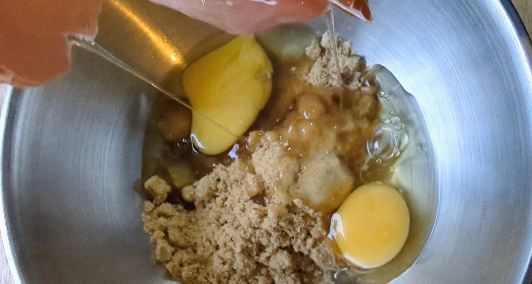 A child cracking an egg into a bowl