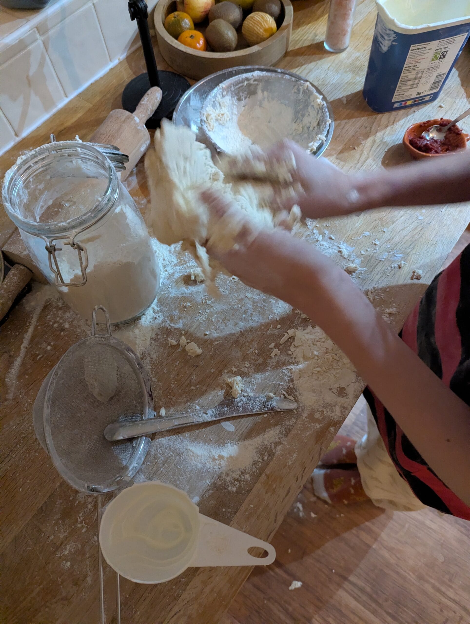 Messy kitchen with children cooking together — 10 reasons to cook with your child